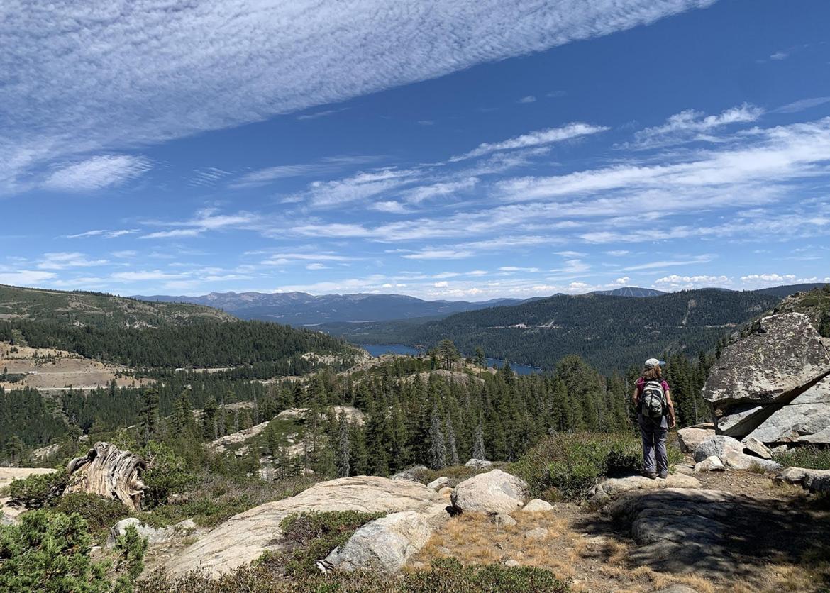 Teen hiking with beautiful mountain and lake scenery at Donner Lake, California