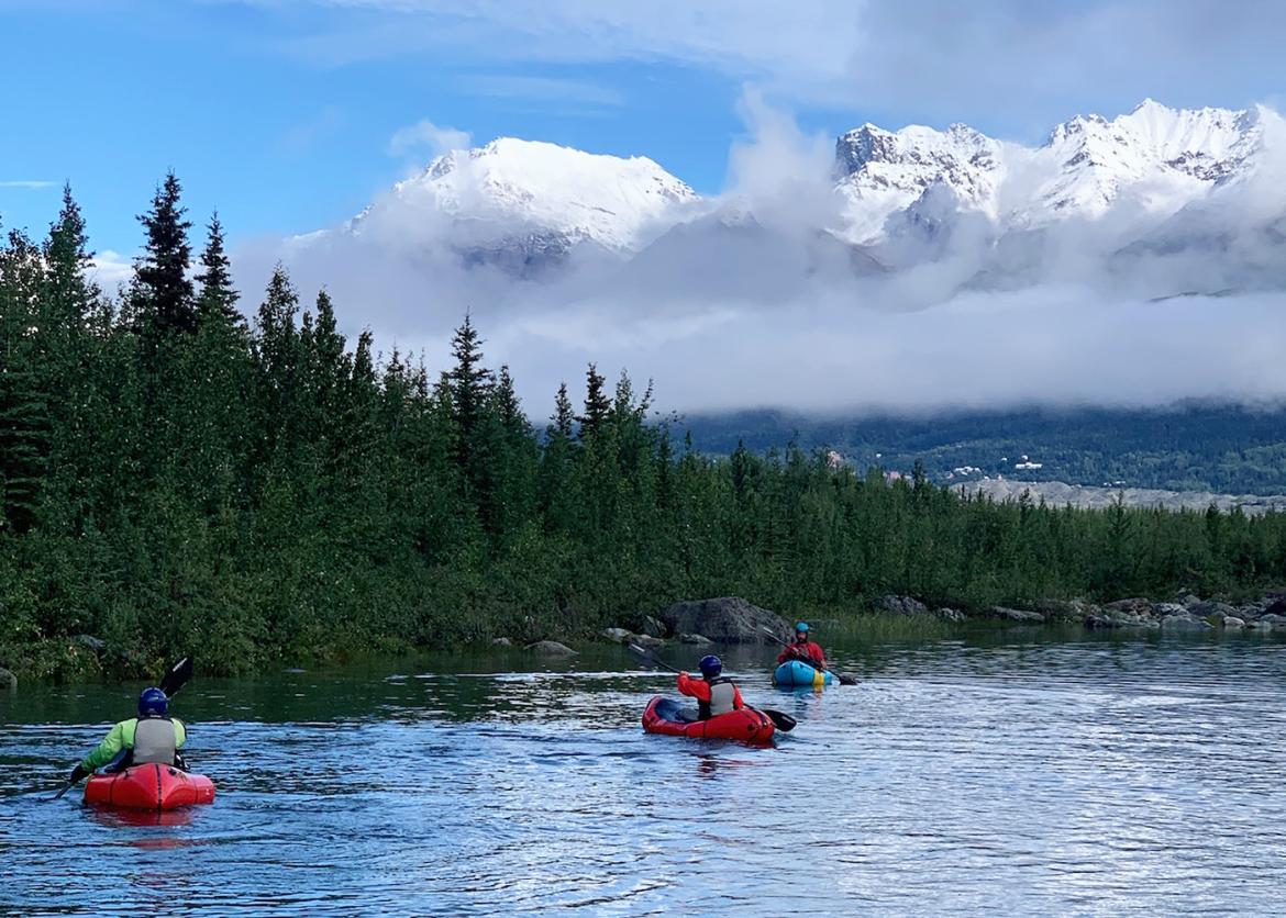 Kayakers in front of snow-capped mountain landscape in Wrangell, Alaska