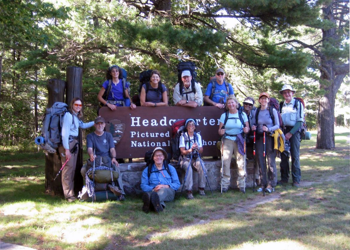 A group of people posing over a sign that says "Headquarter".