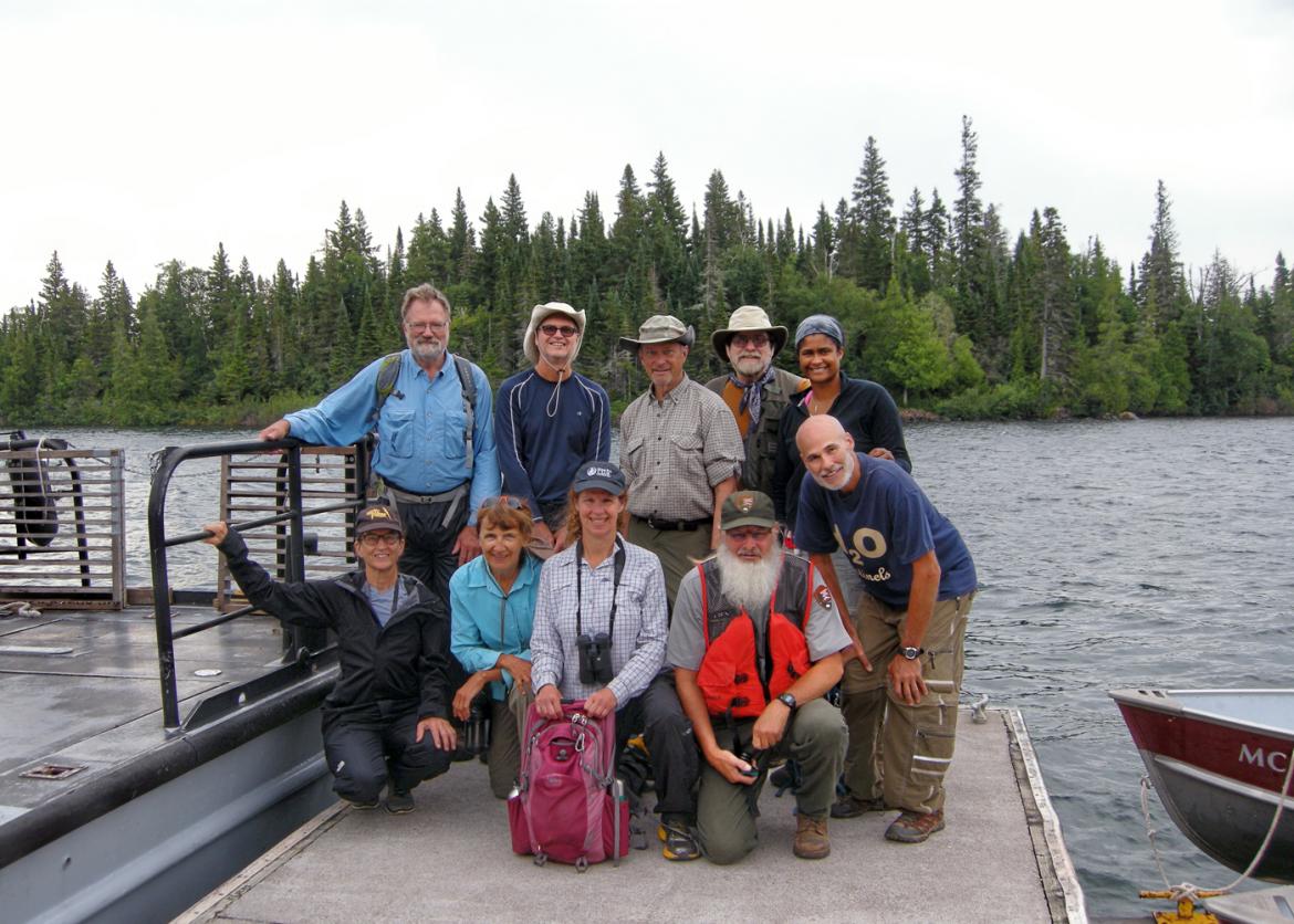 A group smiling with the lake behind them.