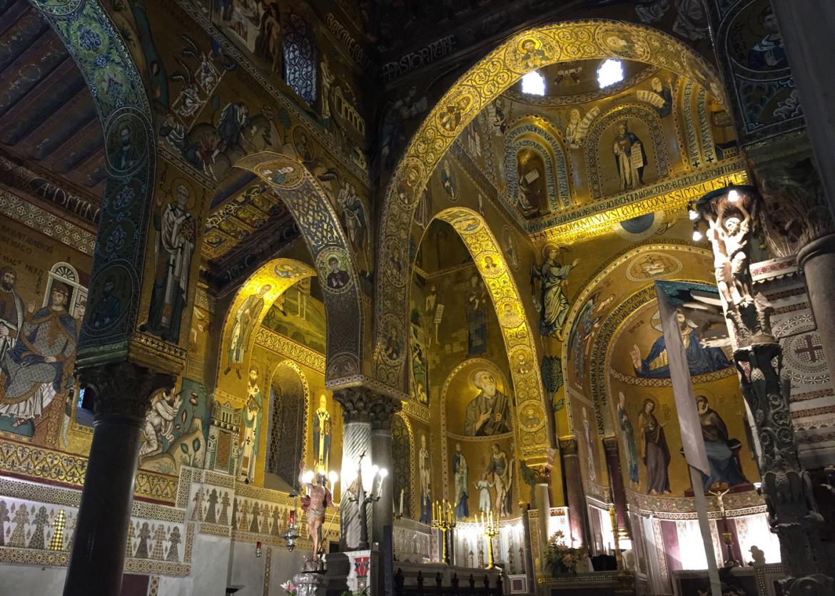 A church ceiling decorated with gold and the icons of saints.