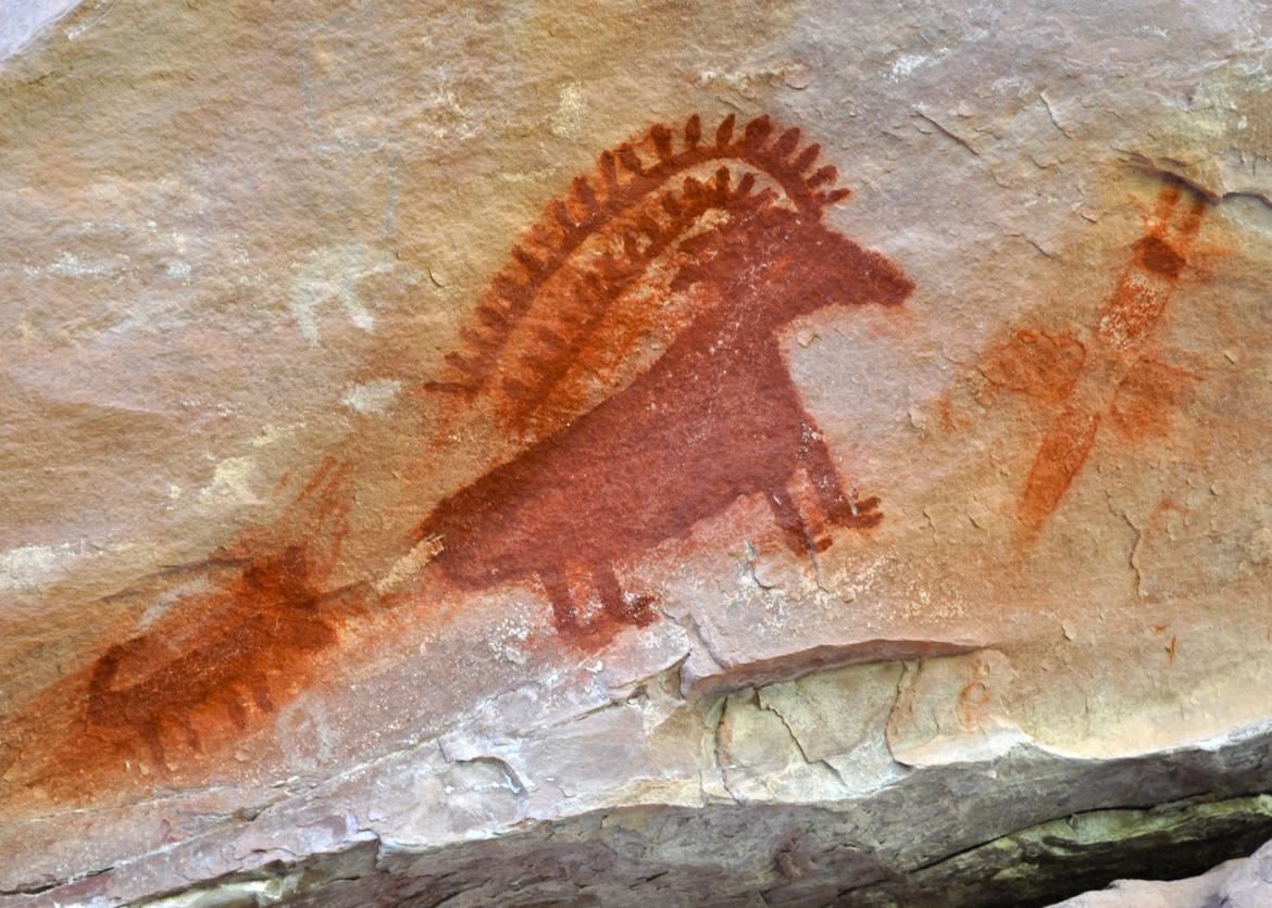 A dinosaur-looking drawing on the rock