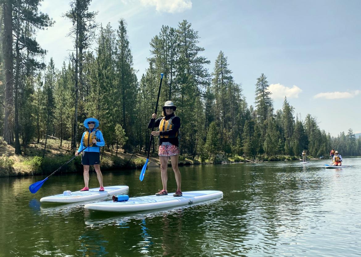 Two people on stand-up paddleboards in the water.