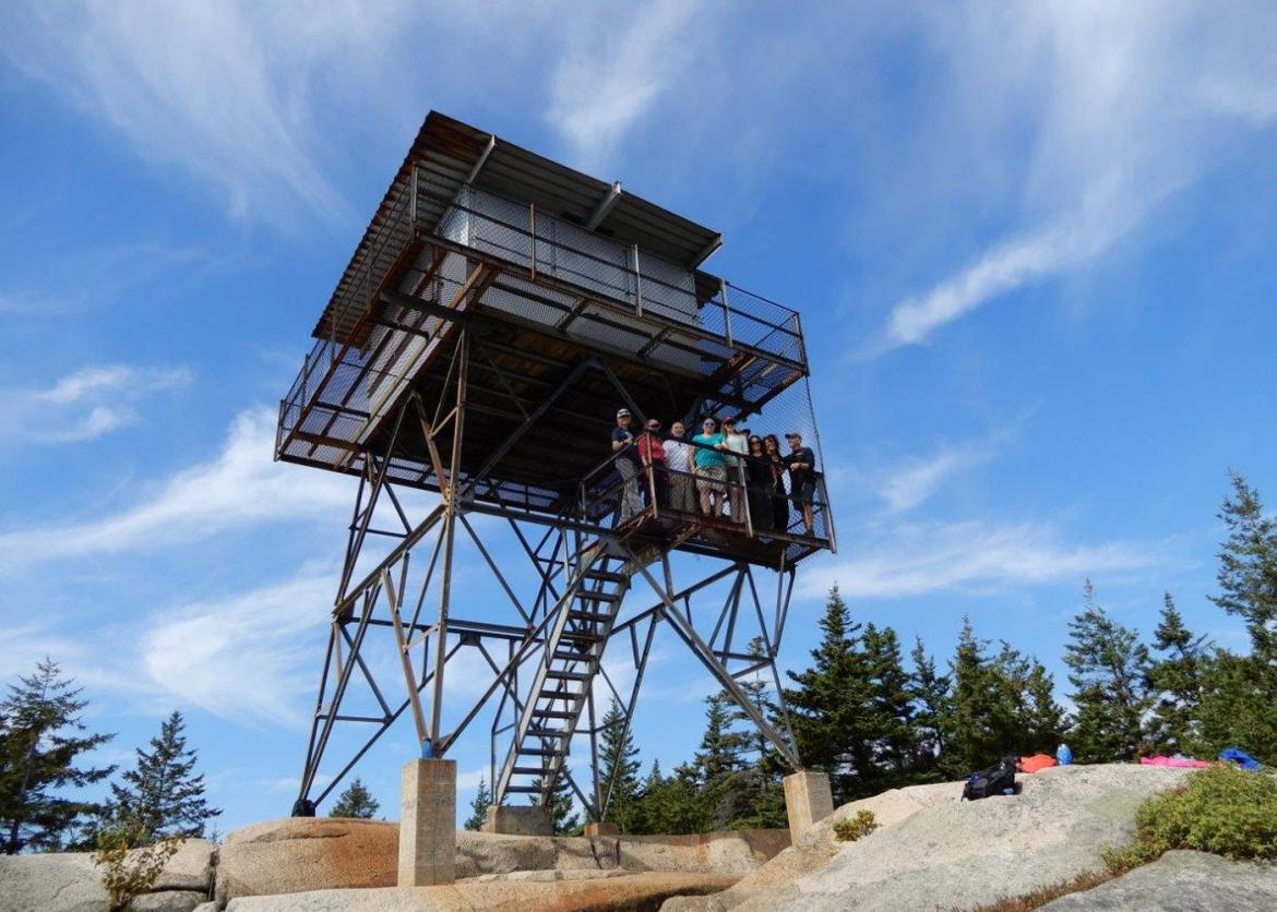 People standing on a high lodge to get a better view of the area.