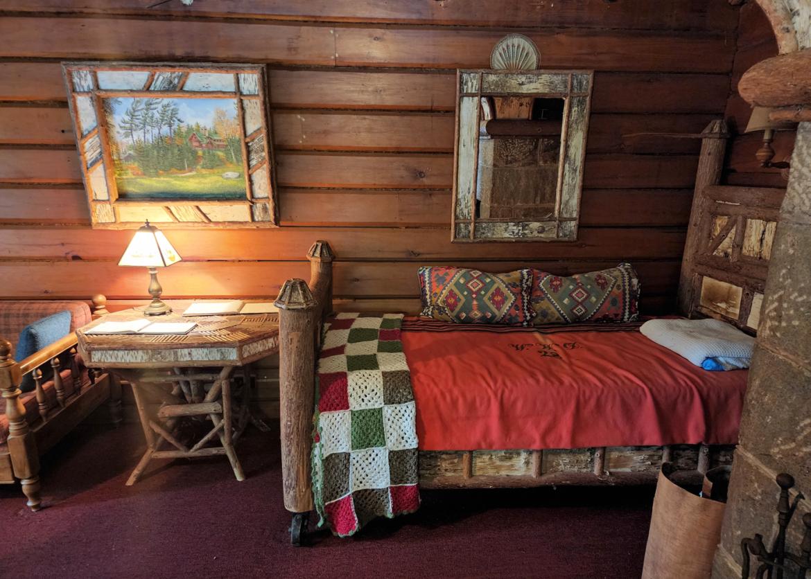 A lodge room with two beds and desk.