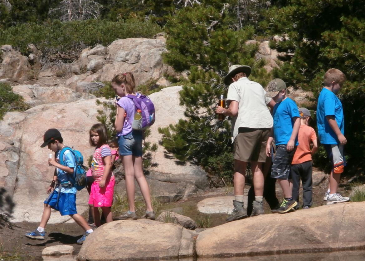 A group of seniors and children hiking together.
