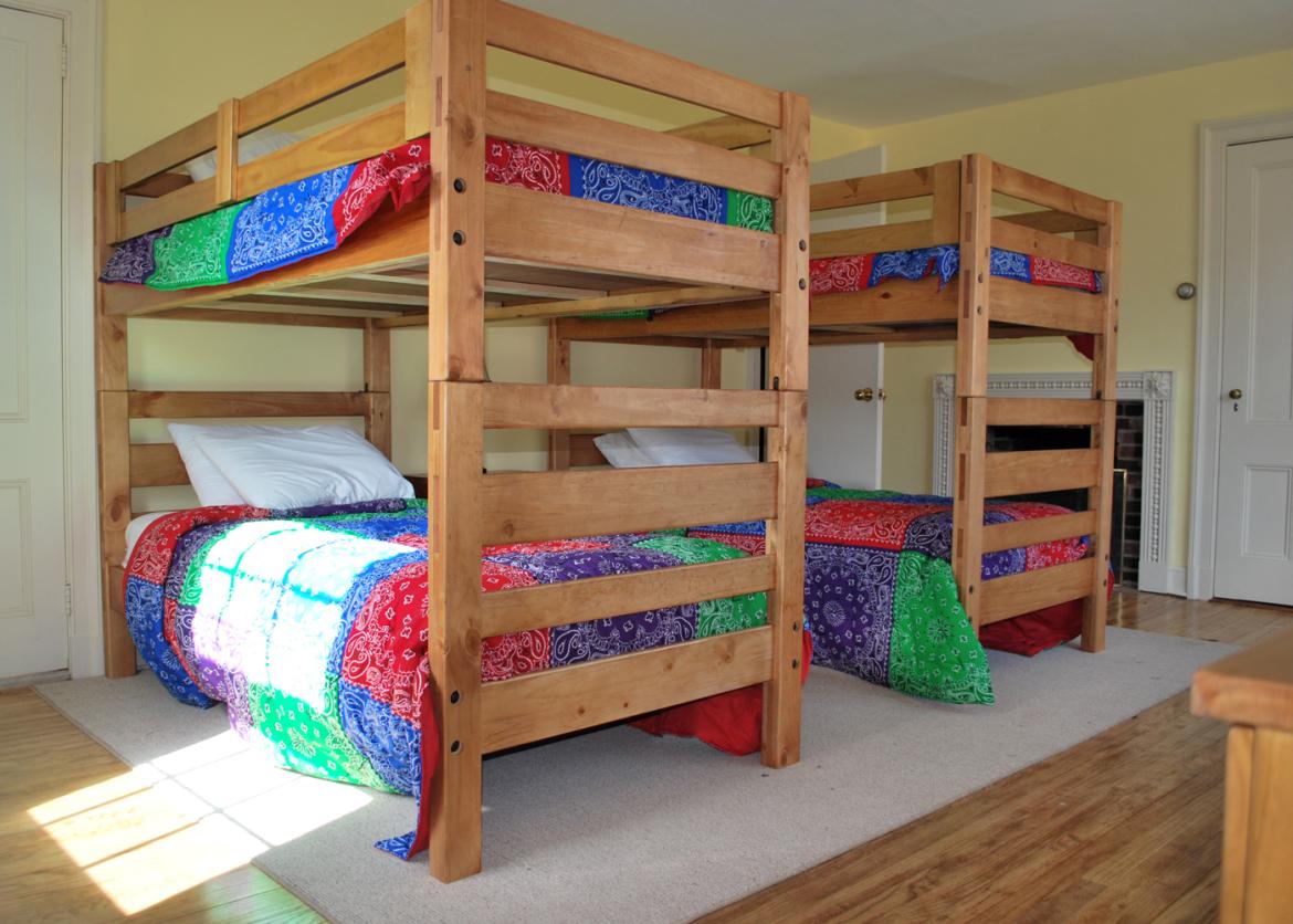 Bunk beds with colorful blankets in the lodges.
