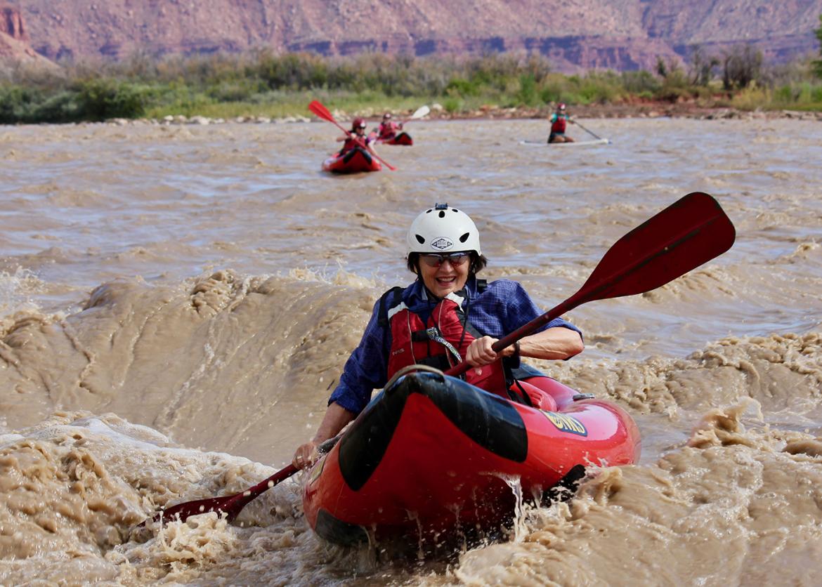 Woman rafting on a rushing river