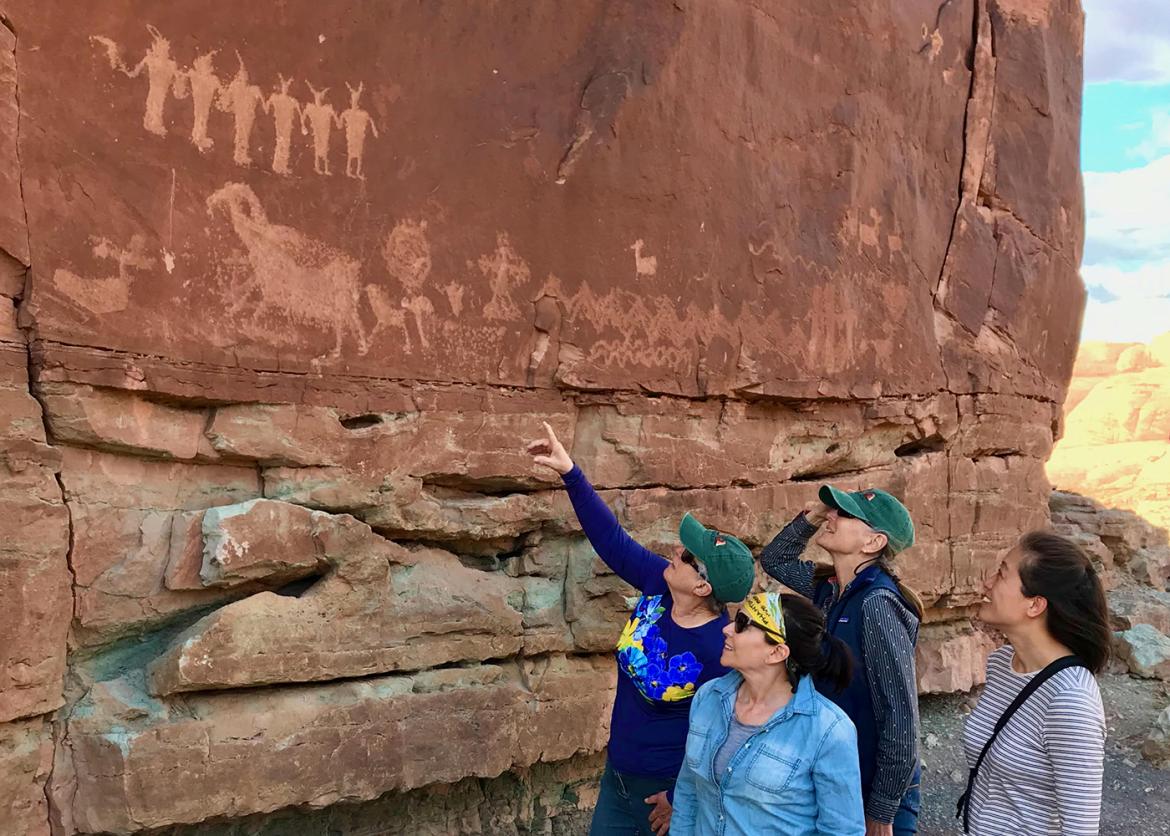 Trip participants viewing Indigenous pictographs on redrock walls
