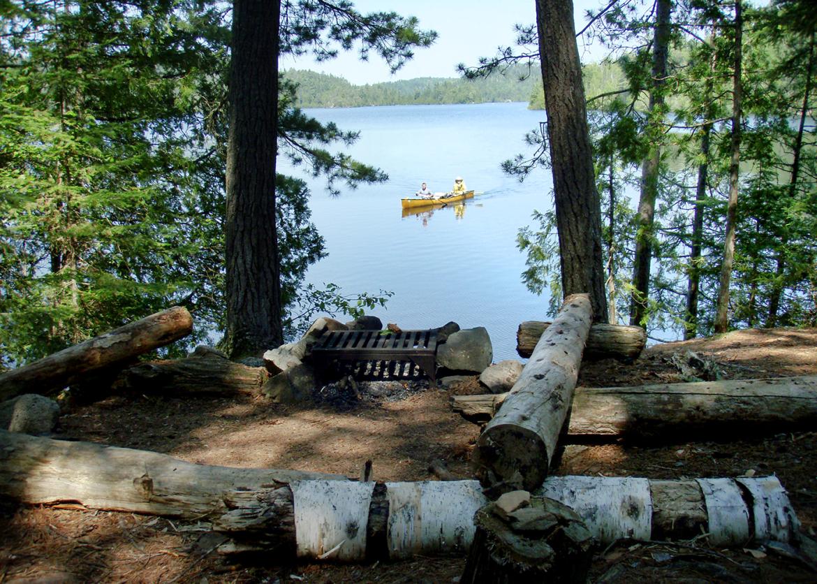 View of kayak on lake through the forest.