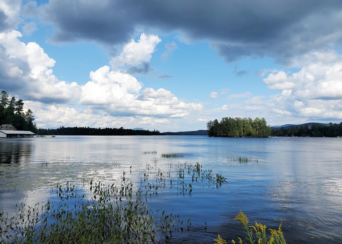 Calm blue lake in the Adirondacks of New York.