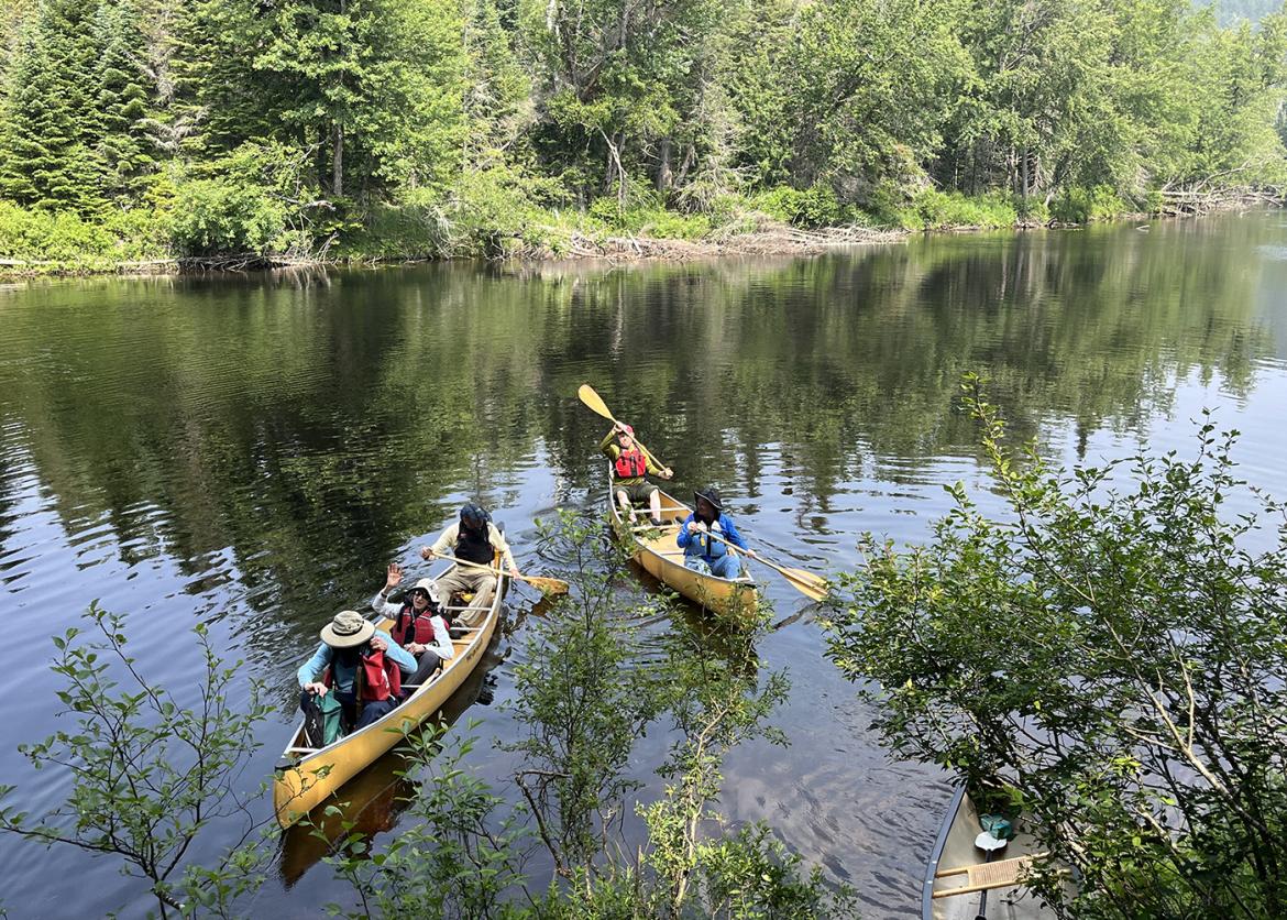 Trip participants in two canoes on a body of water