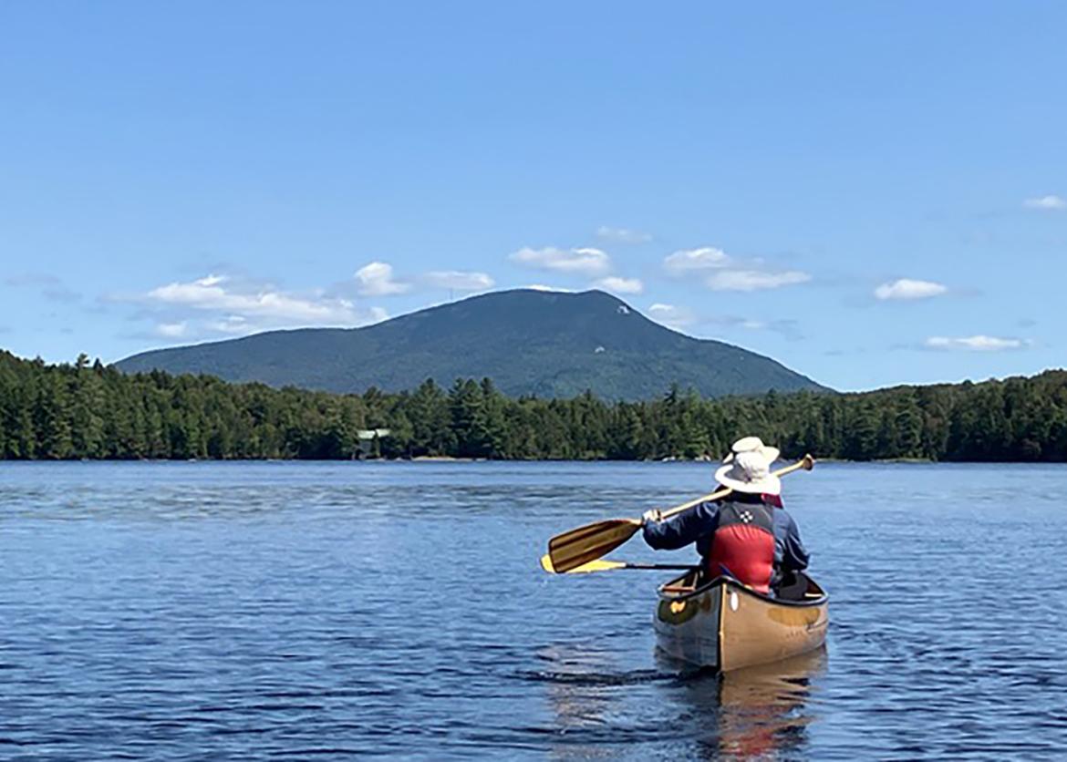 Person canoeing on lake