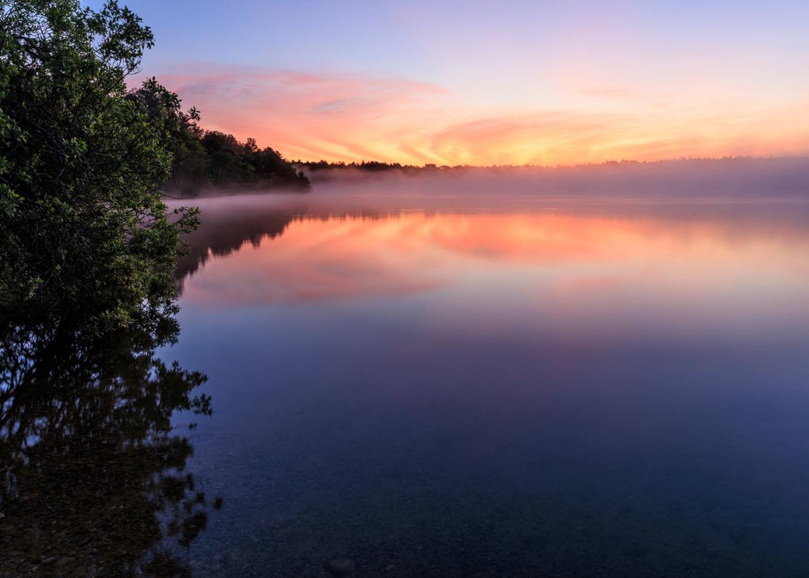 Fog on a lake at sunset