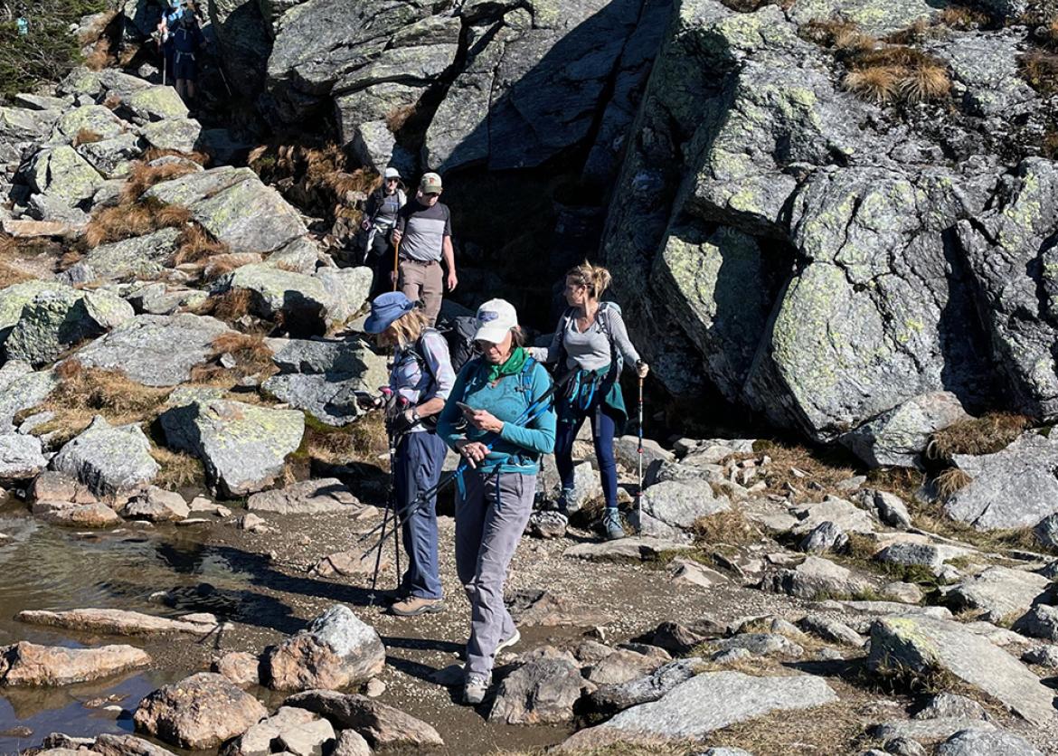 Hikers trek along the rocky trail in New Hampshire