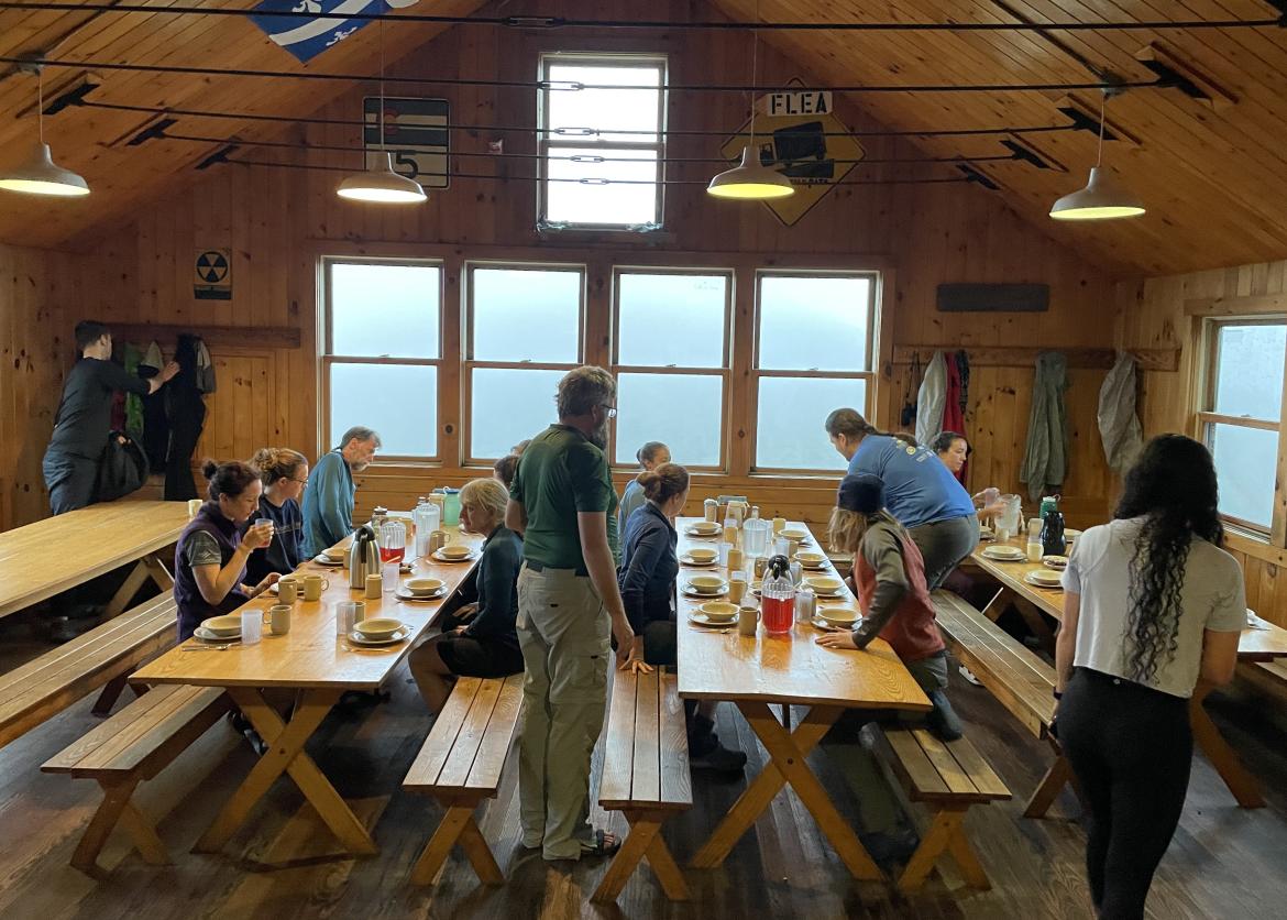 People eating a meal in a spacious lodge.