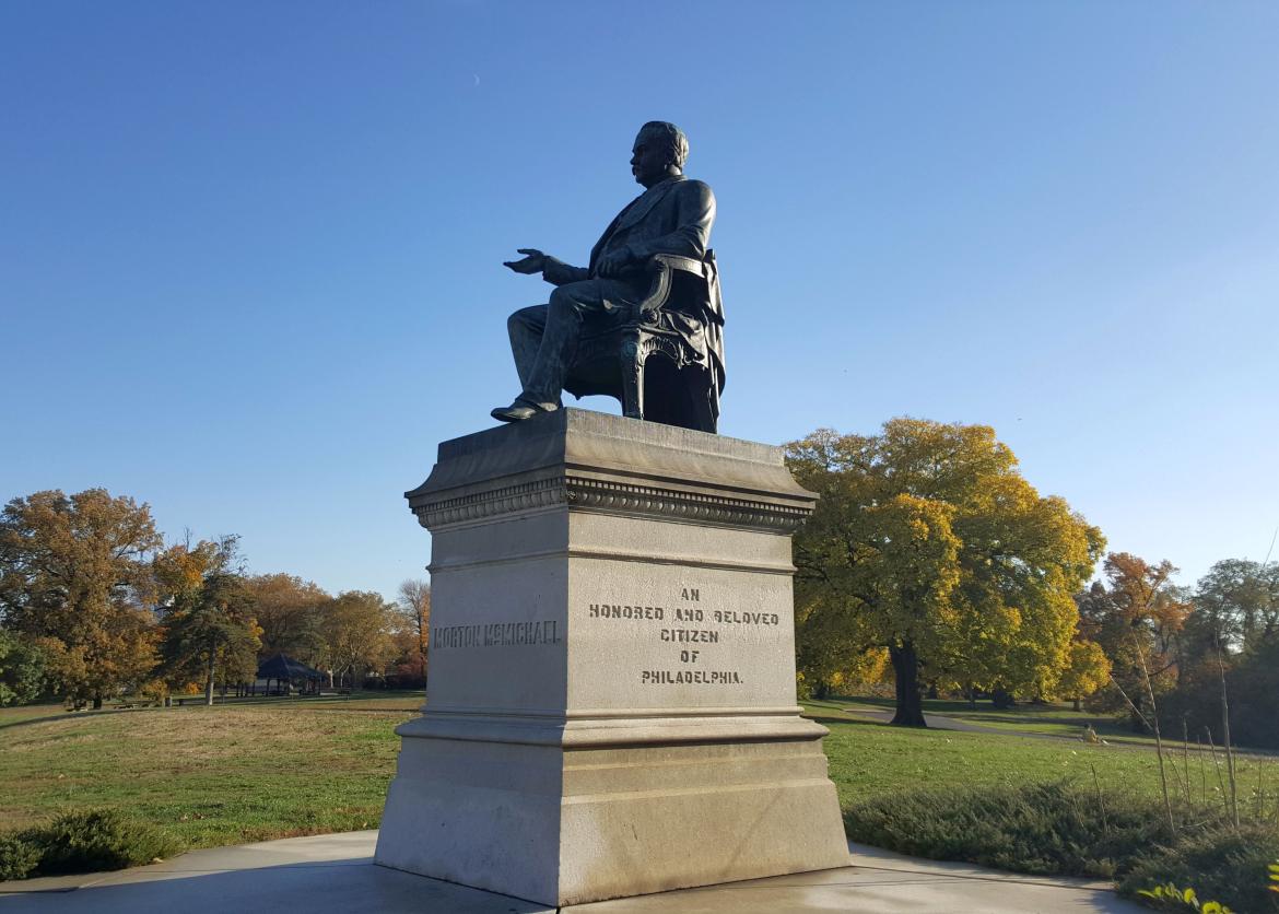 A bronze statue on a carved plinth labeled "Morton McMichael: an honored and beloved citizen of Philidelphia."
