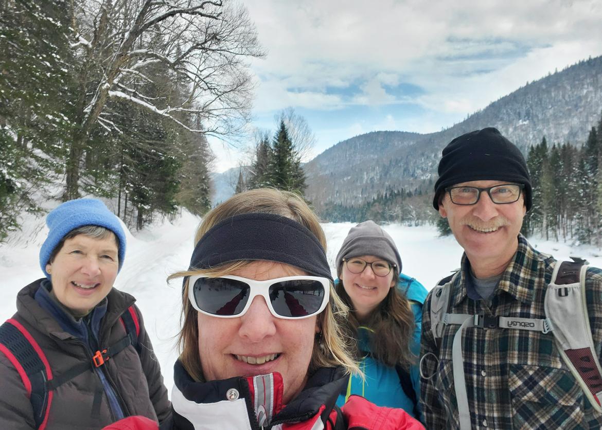 Trip participants snowshoeing in a snowy wonderland in Quebec