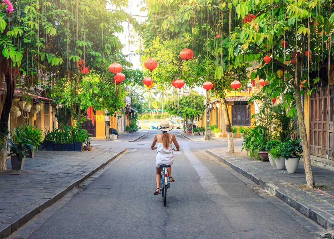 Women bicycling in the old city of Hoi An in Vietnam.