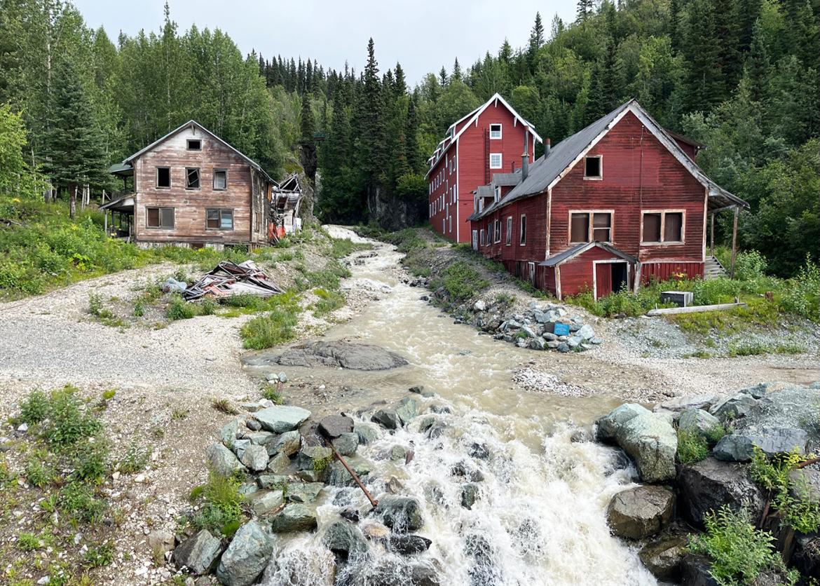 Picturesque red buildings by rushing river near Wrangell St. Elias, Alaska