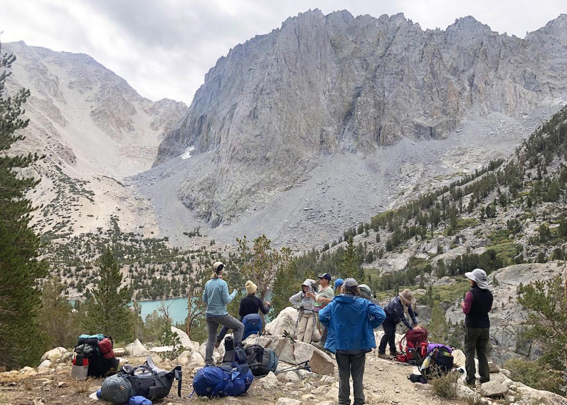 Trip participants in the Eastern Sierras take a break from backpacking to enjoy the mountain view