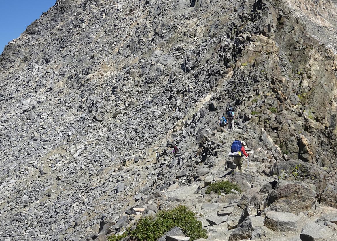 Hikers trekking in rocky Sierra mountain scenery