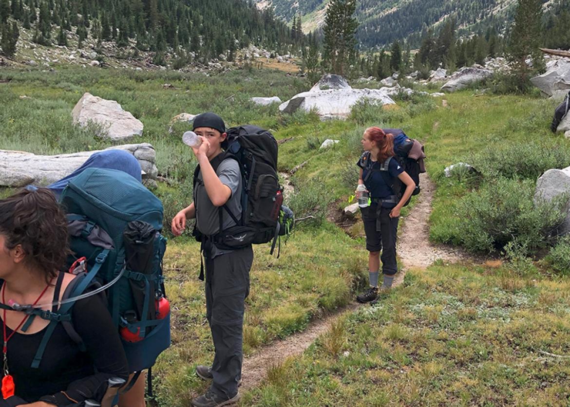 Trip participants pause on the backpacking trail