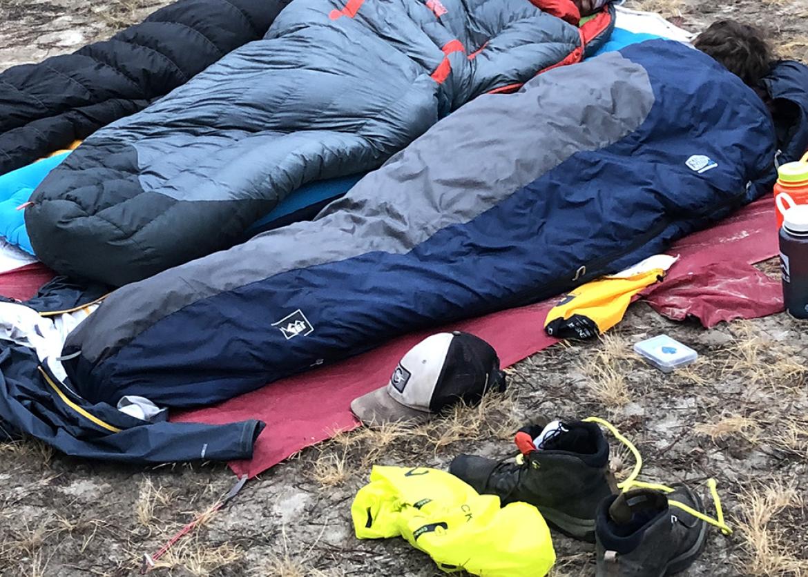 Trip participants asleep in sleeping bags.