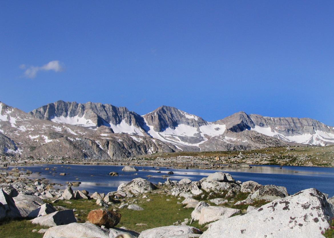 Rocky landscape, lake, and mountain view at Mt. Humphreys in the Sierra Mountains of California.
