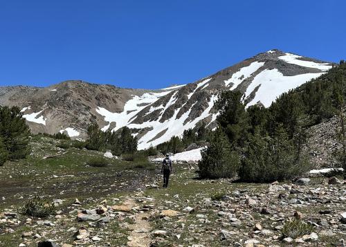 Person hiking through beautiful mountain scenery