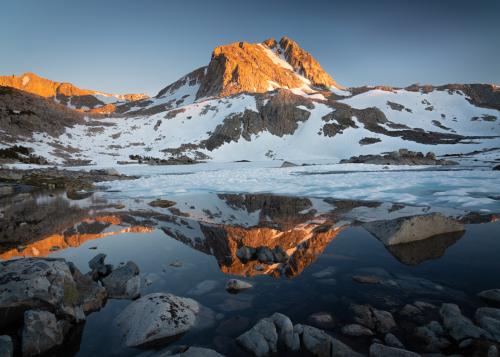 Landscape photo with snow-capped mountain and reflective lake