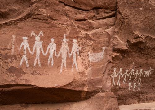 Historical Native American art, canyon walls with painted human figures.